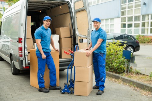 Driver loading household items into a van for a Kentish Town move