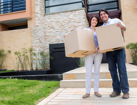 Movers carrying furniture from a flat in Kentish Town